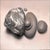 This artwork presents a serene arrangement of smooth stones, showcasing a harmonious balance between organic forms and...