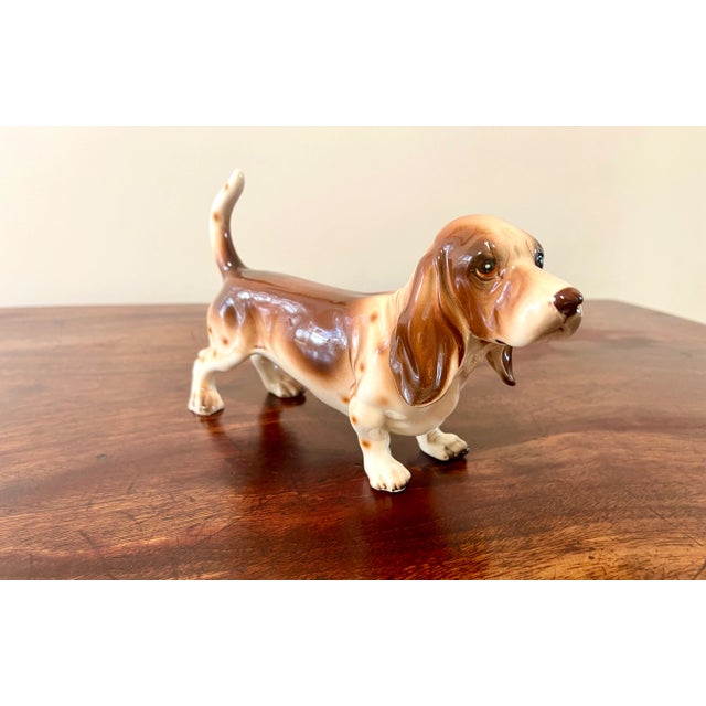Very sweet porcelain figurine of a male Basset hound. Hand painted, lovely articulation and no flaws. Numbered but...