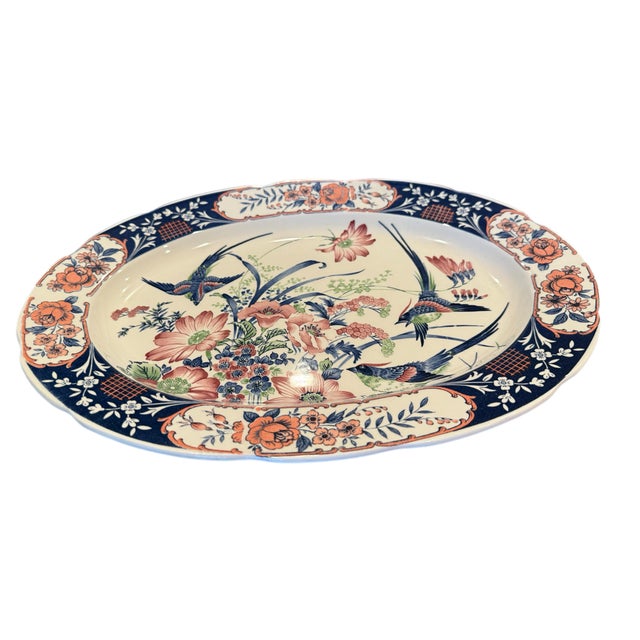 Featuring vibrant illustrations of birds of paradise surrounded by a cascade of flowers and leaves, this large oval...