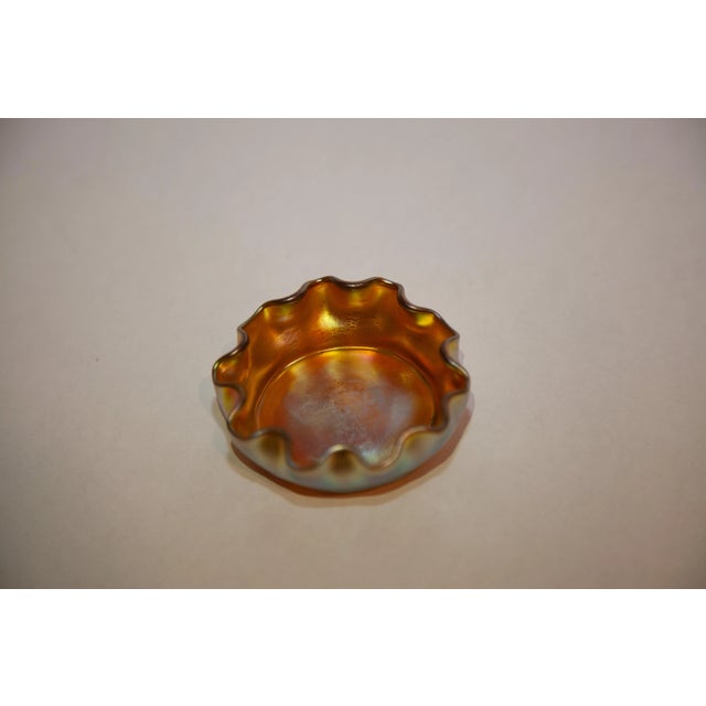 Beautiful Tiffany favrille. Gold iridescent art glass salt dish. This item has vibrant gold iridescence with highlights of...
