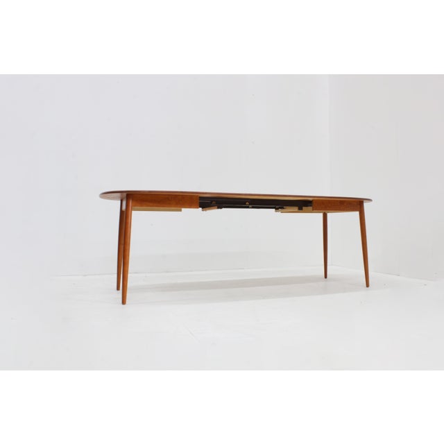 Vintage oval extendable dining table from the 1960s by the Finnish Design brand Asko. Subtle wood grain and scandinavian...
