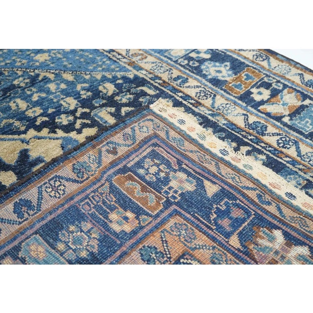 Abrashed dark to royal blue deep, conjoint corners display a scatter of small divided lozenge3s, with presenting a dark...