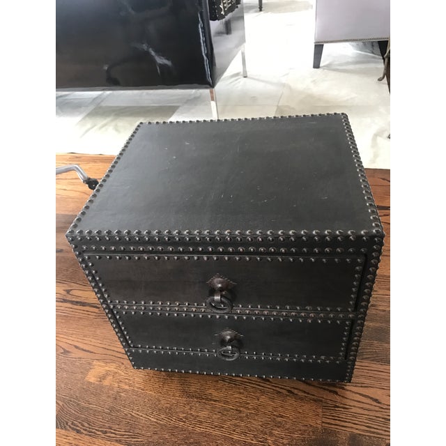 Offering a vintage (80's) two drawer nail head and leather-clad side chest/table from Morocco. It is constructed of...