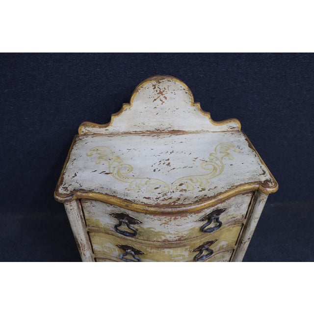 Italian style three-drawer commode with a shaped front, bracket feet, and a raised back splash. The surface is hand-...