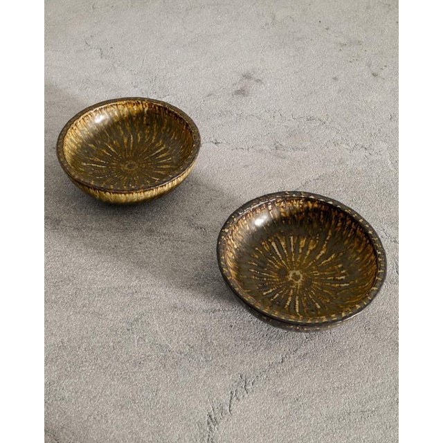 Rare pair of Swedish mid century decorative ceramic bowls in brown golden glaze from the series "Rubus" designed by Gunnar...