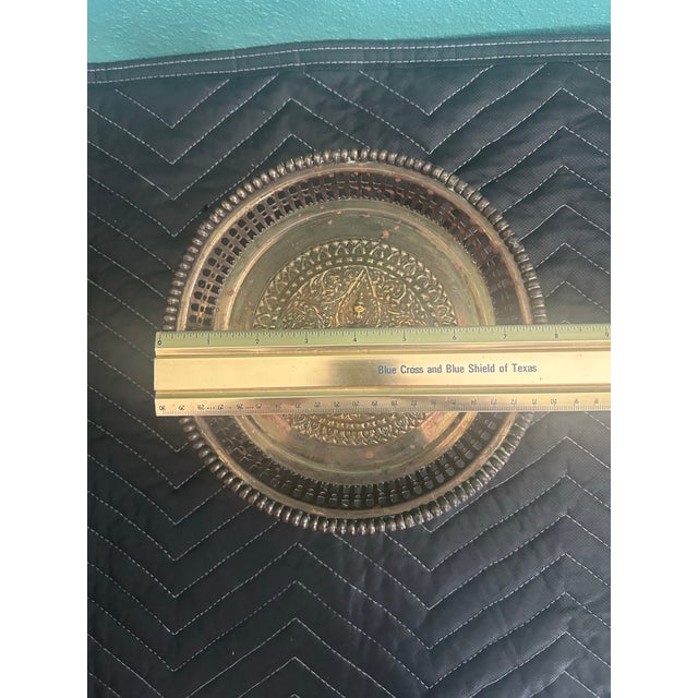 Beautiful vintage Thai brass pedestal offering tray featuring an exceptionally detailed raised central deity figure...