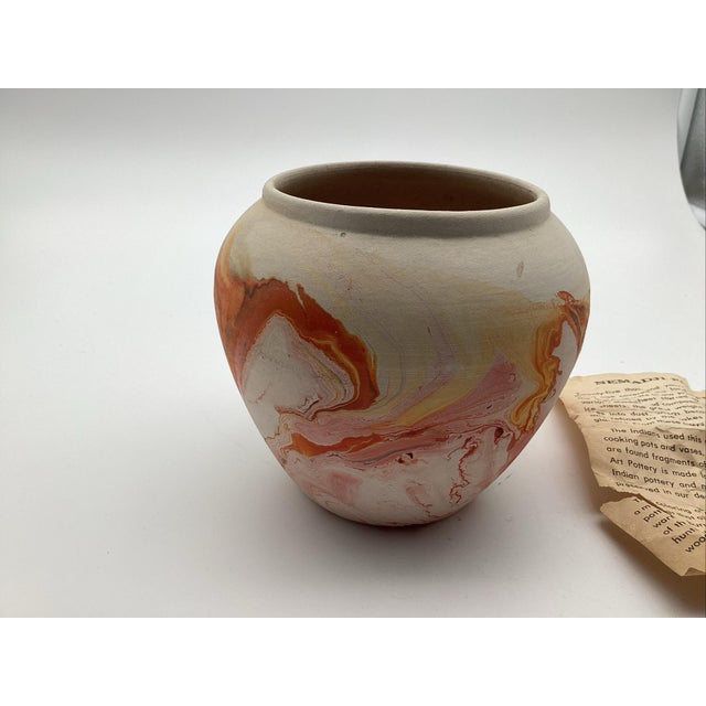 Nemadji pottery was a Native American pottery company founded in 1925. This vase has beautiful oranges and pinks in a...