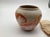 Nemadji pottery was a Native American pottery company founded in 1925. This vase has beautiful oranges and pinks in a...