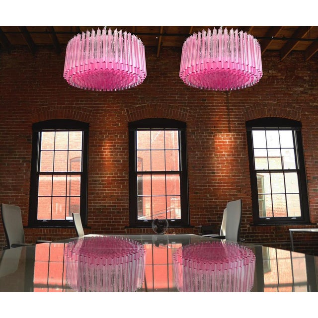 Pair magnificent Murano glass chandeliers, 265 pink triedri on crome frame. This large midcentury Italian chandelier is...