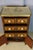 A marquetry side table with floral decoration. This small table opens with three drawers, and the lower section reveals a...