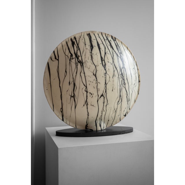 This ambient lamp has a round lampshade with a hand-painted abstract pattern. The lampshade is made of plastic and is...
