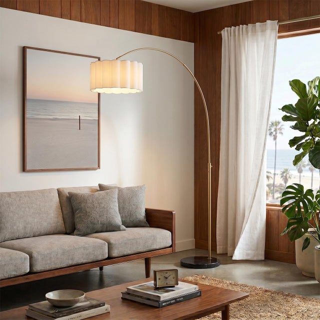 The Scallop Arc Lamp is a modern arc lamp designed by Peter Morelli in 1960, featuring a weathered brass steel body and a...