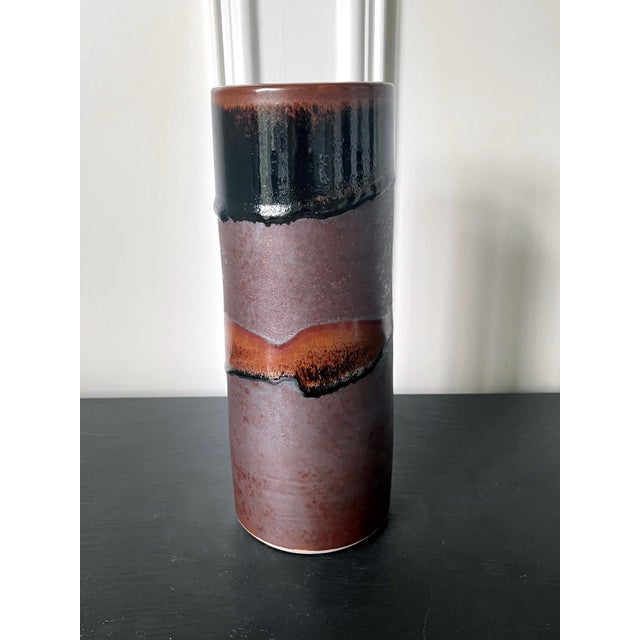 An early ceramic vase in a slightly tapered cylinder form by potter Brother Thomas Bezanson (1929-2007). The minimalistic...