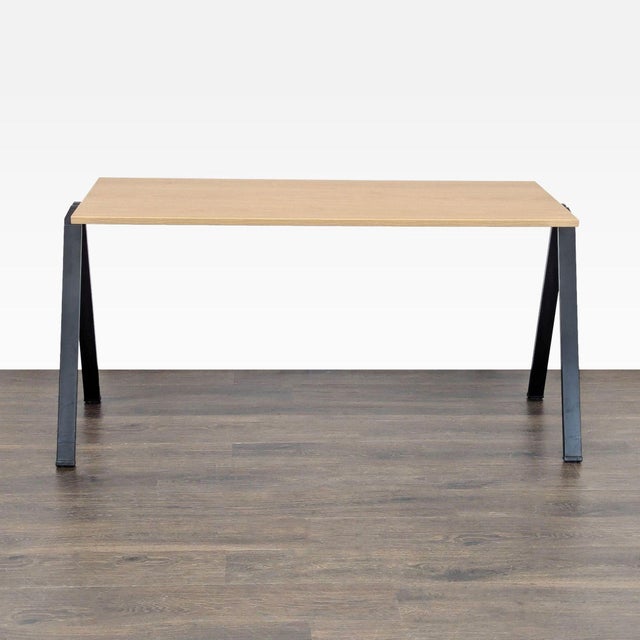 This Bernhardt desk features a simple and modern design with a light laminate wood top and sturdy black metal legs. Its...
