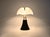 Black metal and plastic lamp by Gae Aulenti. Adjustable height: min: 70cm max: 90cm. Stamped under the lamp. Wear...