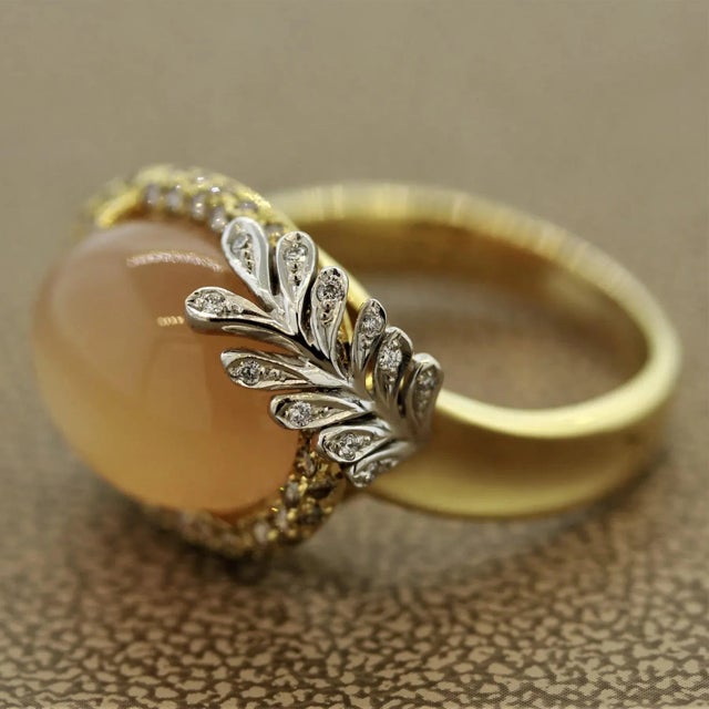 A lovely soft orange moonstone ring out of a fairytale. The moonstone weighs 8.69 carats and has excellent adularescence...