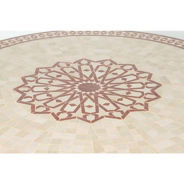 Handcrafted round Moroccan outdoor mosaic tile table 47in diameter on iron base. Classic and elegant Moroccan outdoor...