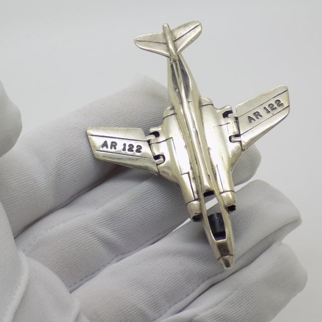 Combining historical military prestige with clever mechanical design, this vintage silver miniature model depicts the...