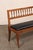 A vintage wooden bench with upholstered seat from US furniture maker and interior designer, Yale R. Burge. This well-...