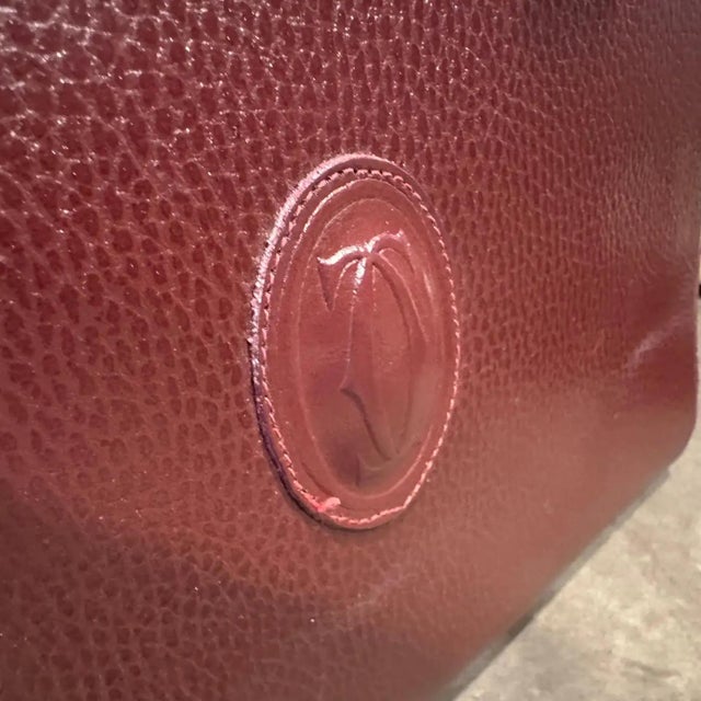 A 1990s Elegant Bordeaux Leather and Brass Top Handle Bag by Cartier For Sale - Image 15 of 15
