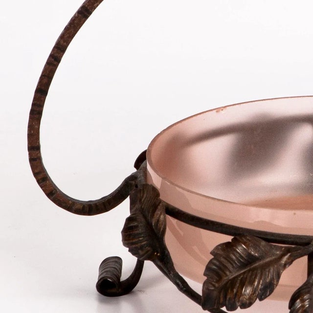 Beautiful Art deco wrought iron basket decorated with a lovely foliate motif and a pink glass bowl insert. France, circa...