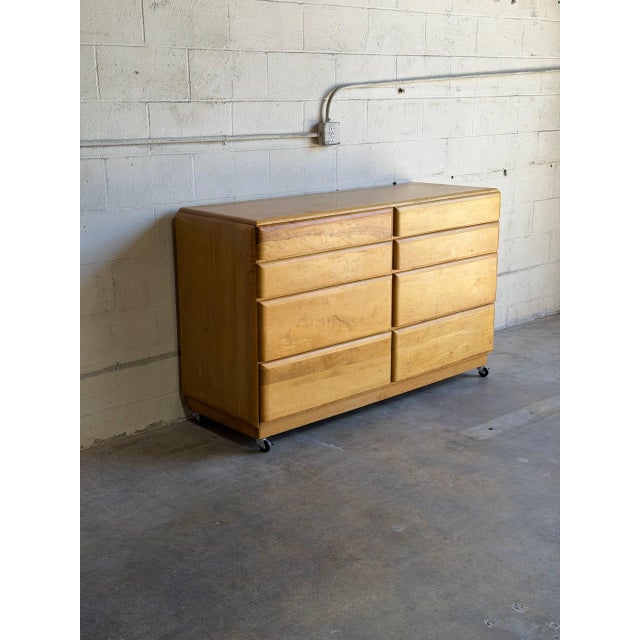 This lowboy features a streamlined silhouette with eight spacious flush storage drawers. The soft curves and clean lines...