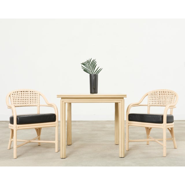 Iconic set of four McGuire barrel back design rattan dining armchairs made in the California coastal organic modern style....