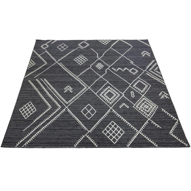 This is a beautiful kilim handmade wool rug with a charcoal gray field. This custom modern flatweave rug from our...