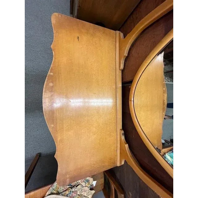 Princess dresser of bird's eye maple with oval mirror, paw feet, serpentine front In found condition