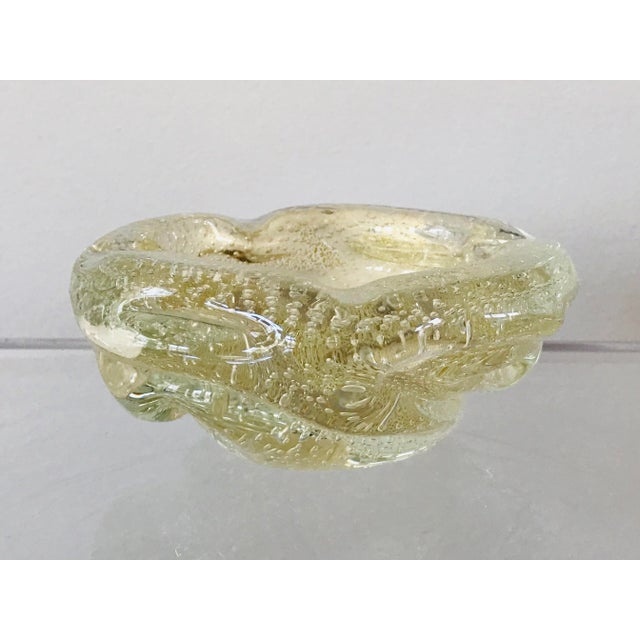 A blown glass ashtray with gold Aventurine flecks and Bullicante controlled bubbles. Unsigned and attributed to Barovier...