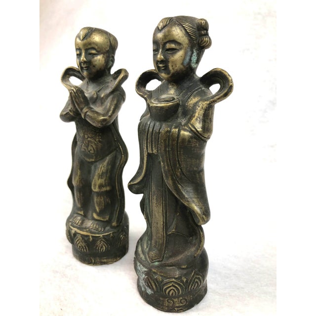 This pair of carved brass boy and girl are from China. They have been lovingly stored away for decades. A bit of tarnish...