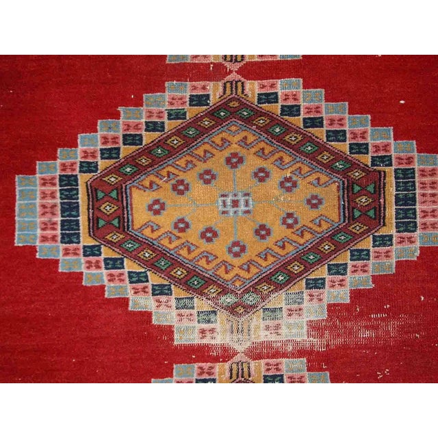 Handmade vintage Uzbek distressed rug in bright red wool. It has been made in the middle of 20th century in Central Asia....