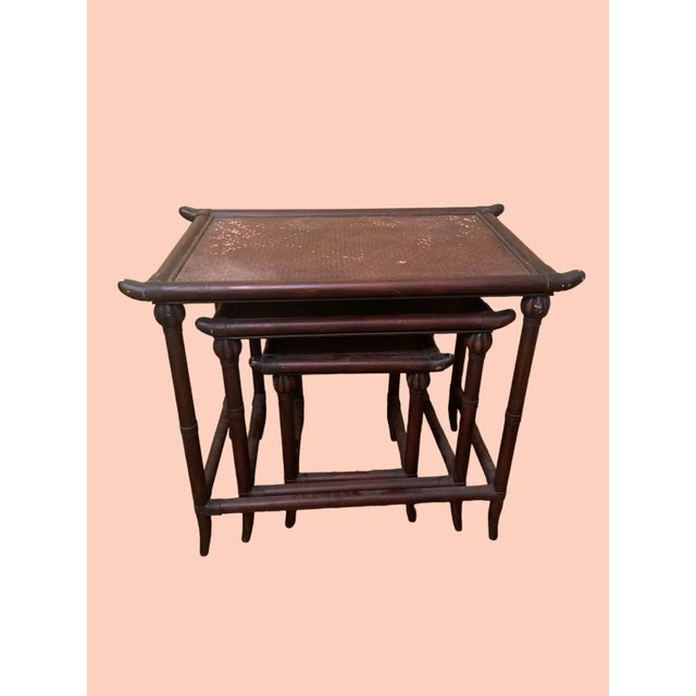 Set of 3 brown Pagoda bamboo nesting tables with cane top Tables are great,show signs of age. Needs spray paint on top