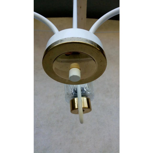 Nice Retro Vintage Chandelier. It has a white holder with bronze accessories of golden color. 3 light elements made of...