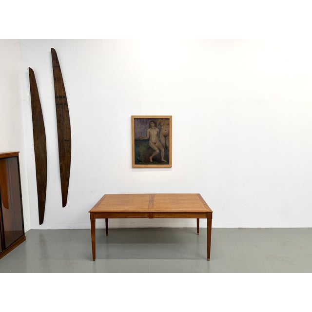 This 1950s dining table is a remarkable piece of furniture, distinguished by its understated elegance and robust...