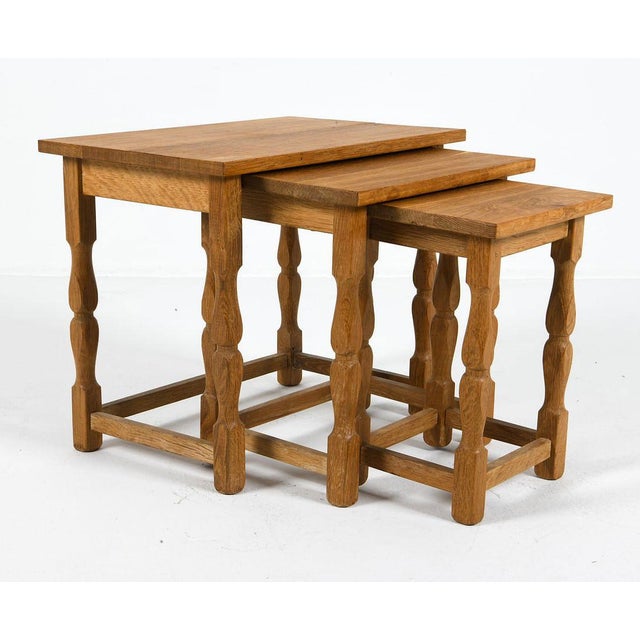 Grouping of (3) solid oak nesting tables in the design attributed to Henning Kjaernulf (1911-1975). Unmarked. Made in...