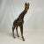 Offering a dramatic safari leather wrapped Giraffe tabletop figurine from the 1970s. This guy stands tall at 16.5” and...