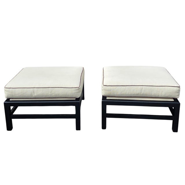 A sophisticated pair of Baker Furniture square upholstered ottomans, each measuring 26.5 inches square by 18 inches high....