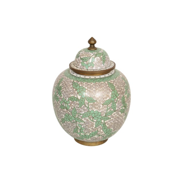 A 1940’s Chinese cloisonné lidded ginger jar in jade and taupe. Jade green colored foliage and a jade bitong motif around...