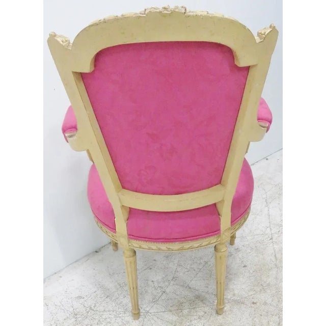 French hand carved fauteuil with cream painted finish and pink upholstery, small stain on seat. Seat Height 19"