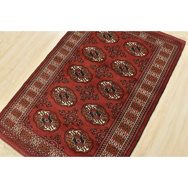 An authentic vintage tribal Turkmen rug hand-knotted with fine wool and natural dyes. This nomadic oriental rug features...