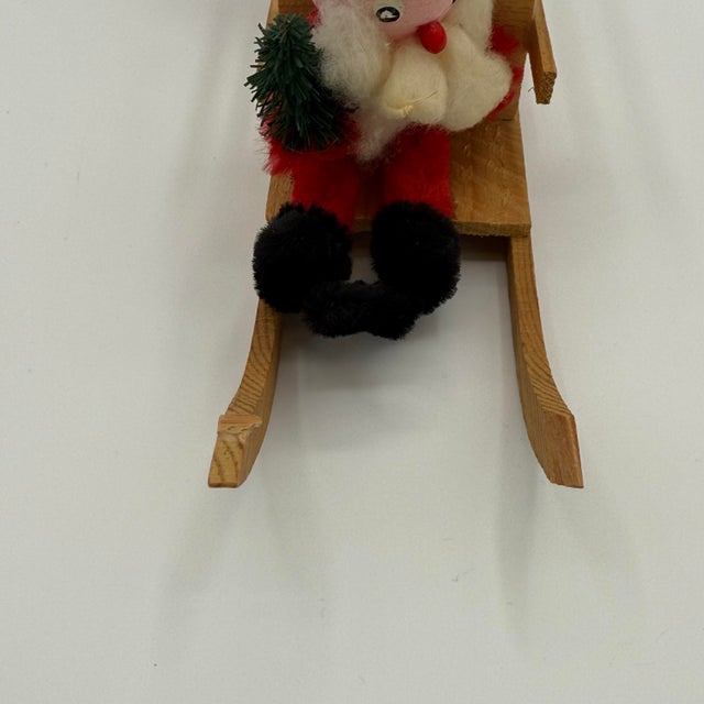 Charming mid-century Santa Claus figure riding in a wooden sled, likely made in Germany in the 1950s–60s. Santa has a...