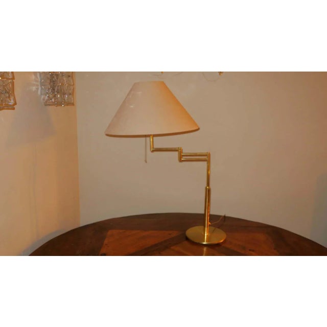Relux Milano Italian mid century table lamp or reading lamp in brass. The lamp is multi-adjustable by means of a swing...