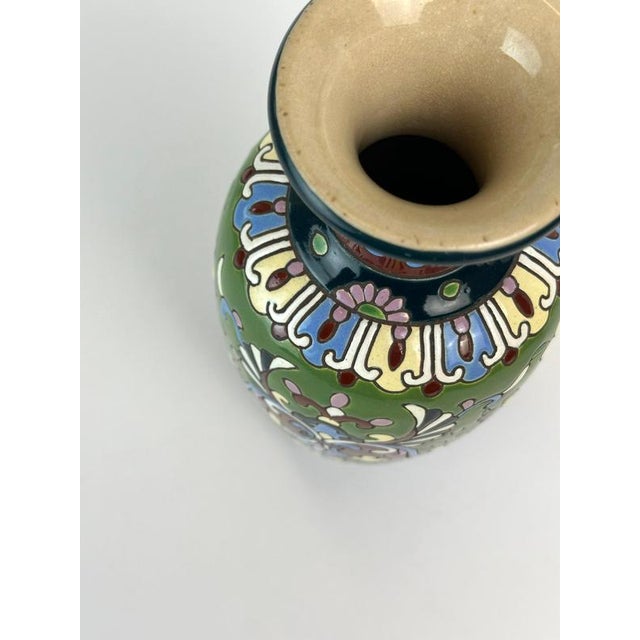 This small French faience vase attributed to a maker in the Longwy region dates from the early 20th century and presents a...