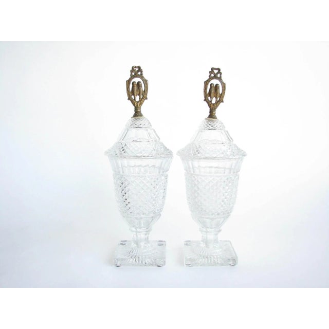 Antique diamond cut glass lidded urns with brass lovebird finials. Originally lidded urns and once converted to lamps....