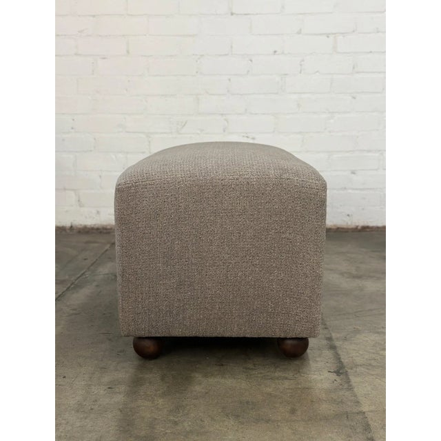 W42 D20.5 H20 Handcrafted Basico ottoman in Cobblestone Gray. Rectangular shaped with solid wood handturned ball legs in a...