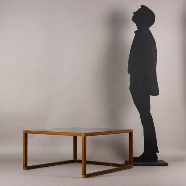 Coffee table, brass frame, smoked glass top. This piece is attributed to the mentioned designer/maker. It has no...