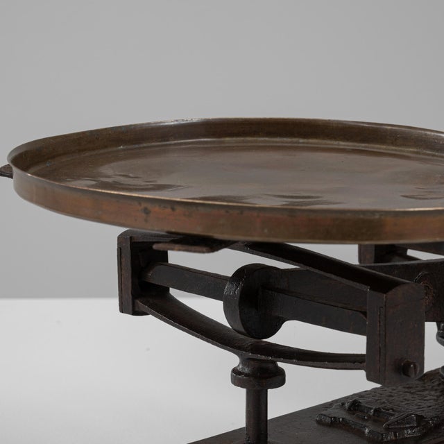 This 19th Century French iron and brass scale presents a beautifully balanced combination of industrial form and warm...