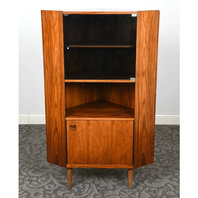 Vintage Danish Modern corner cabinet from the 1960s, featuring richly figured rosewood veneer, clean architectural lines,...