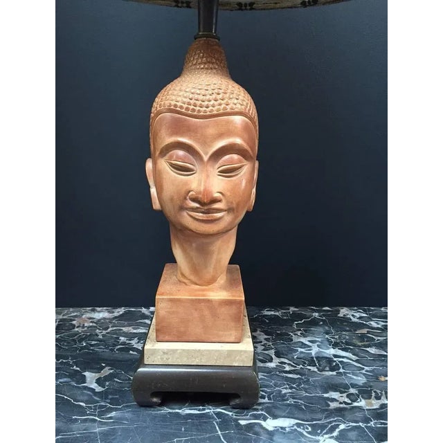 Beautifully carved wooden Buddha head with tribal shade.